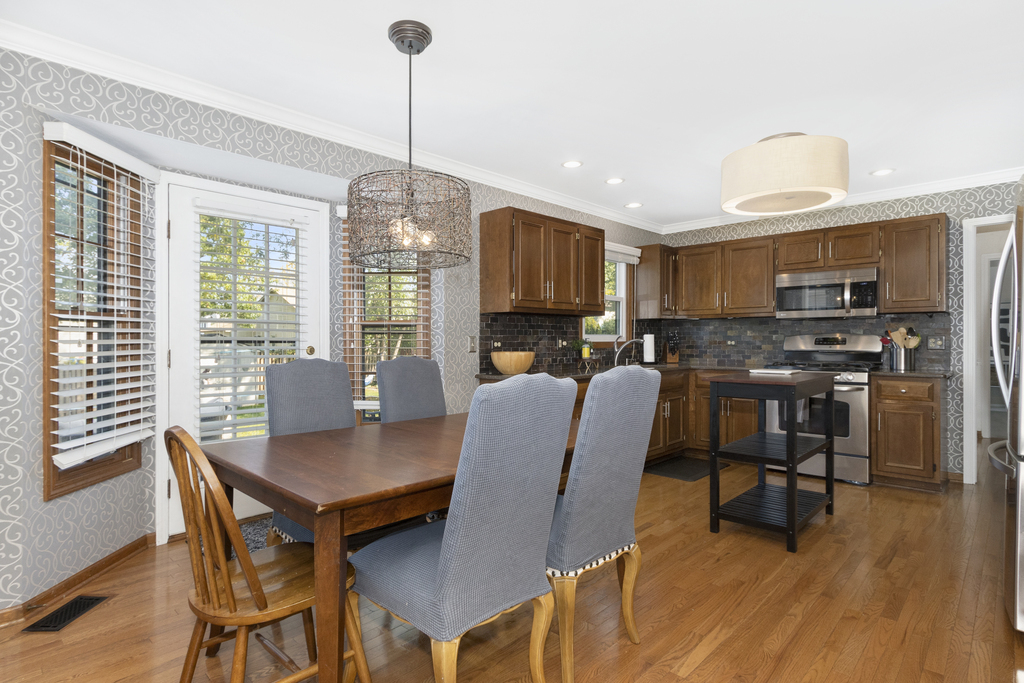 1712 Mundelein Road Naperville, IL 60565 - Photo 3 of 42 a view of a dining room with furniture window and wooden floor