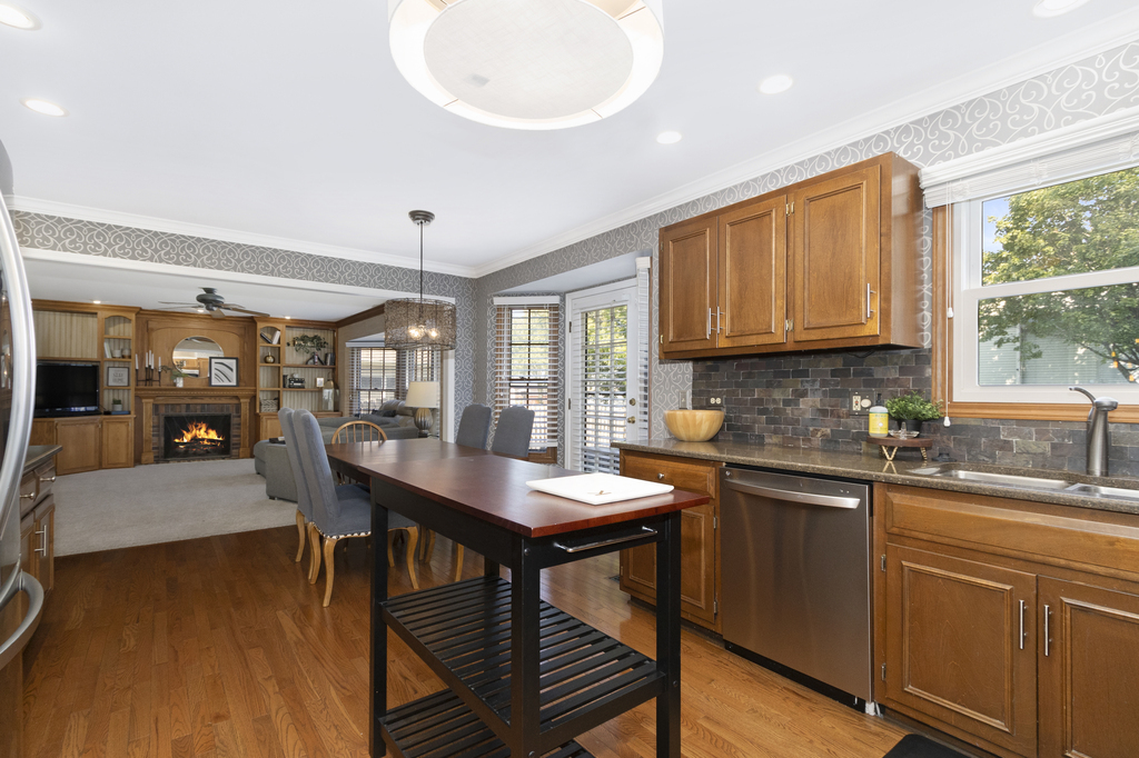 1712 Mundelein Road Naperville, IL 60565 - Photo 5 of 42 a kitchen with stainless steel appliances granite countertop a stove a sink dishwasher and a microwave oven with cabinets