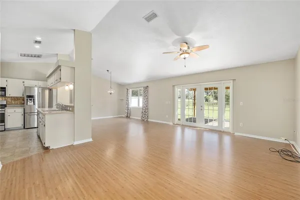 a view of a kitchen with a refrigerator wooden cabinets and a sink