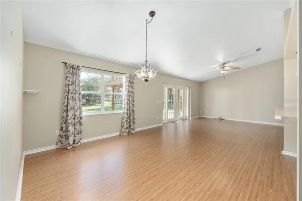 a view of a room with a ceiling fan and a window