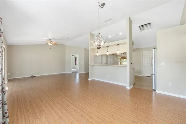 a view of a room with a ceiling fan and window
