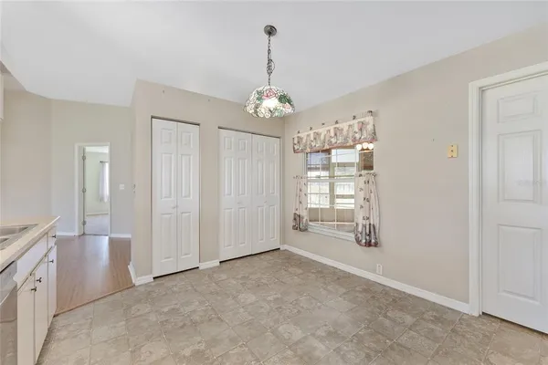 an empty room with a ceiling fan and a window