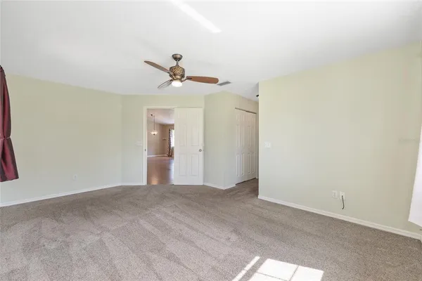 a view of a white house with a yard and a table and chairs