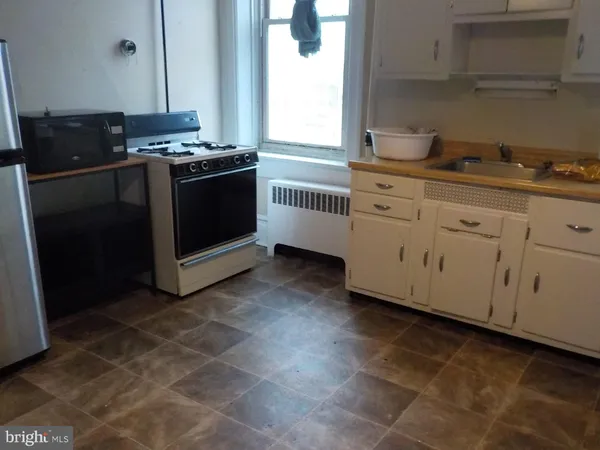 a kitchen with cabinets and appliances