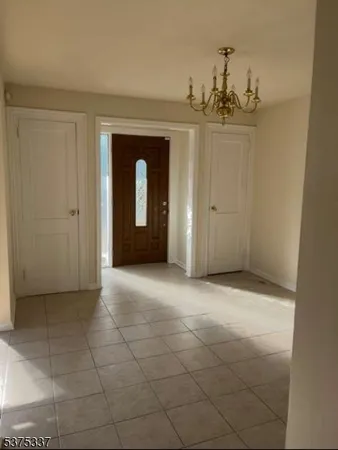 a view of a hallway with a chandelier