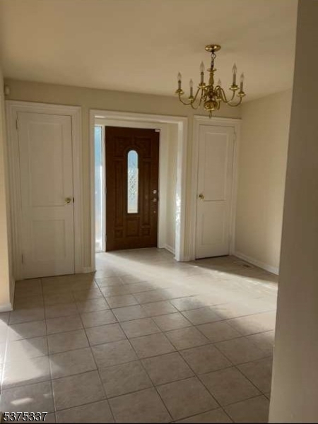 134 Tingley Lane Edison, NJ 08820 - Photo 5 of 10 a view of a hallway with a chandelier
