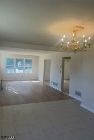 a view of a hallway with chandelier