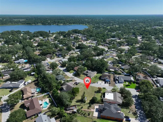an aerial view of a houses with a lake view