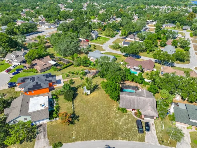 an aerial view of a houses with yard