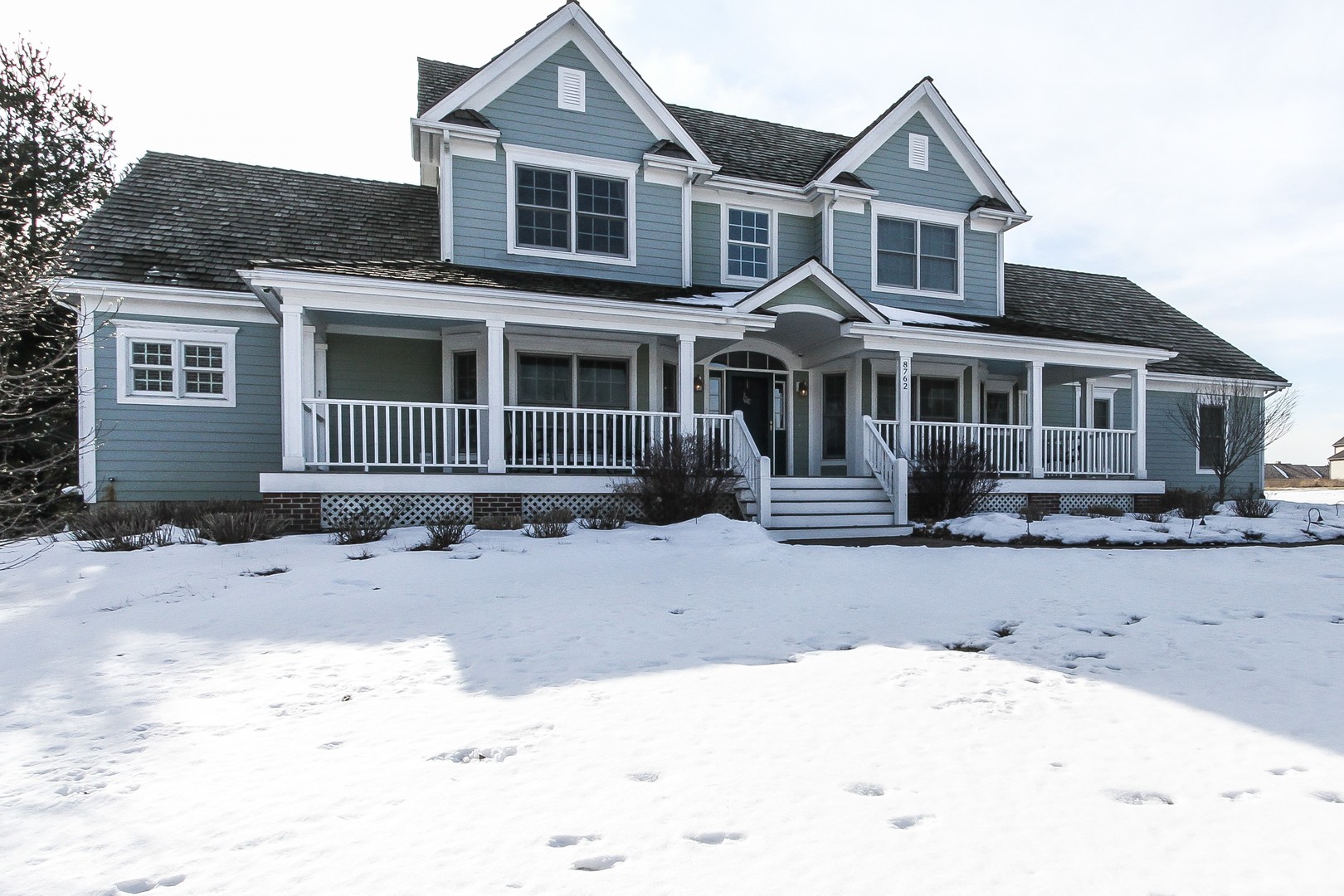 8762 Country Shire Lane Spring Grove, IL 60081 - Photo 1 of 39 a front view of a house with a yard