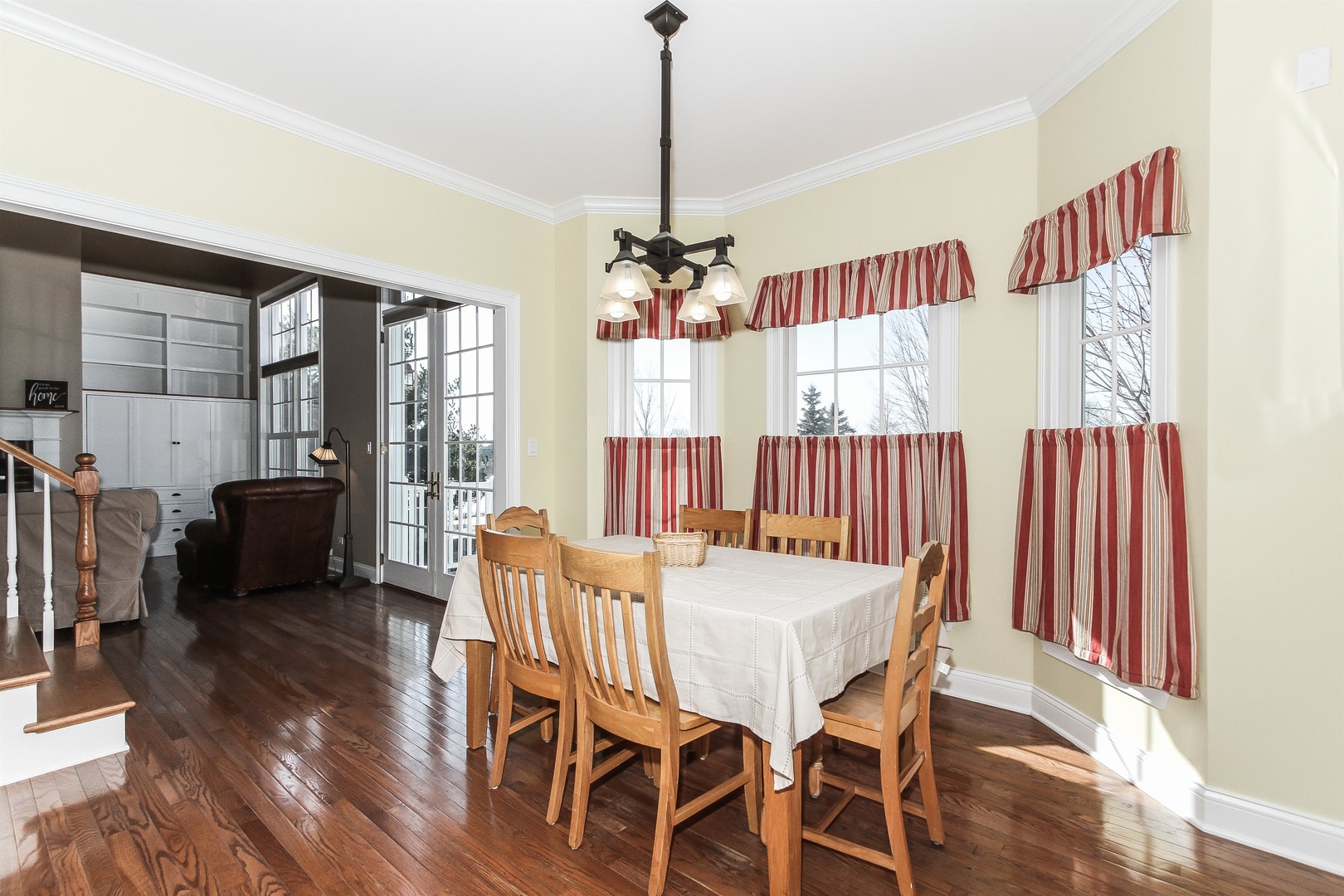 8762 Country Shire Lane Spring Grove, IL 60081 - Photo 11 of 39 a dining room with furniture a chandelier and wooden floor
