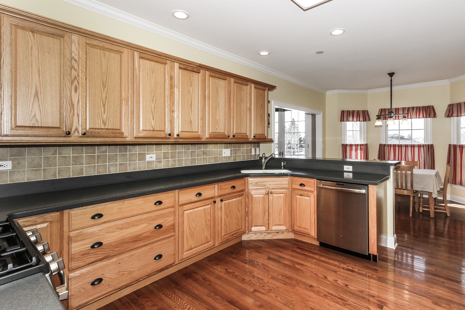 8762 Country Shire Lane Spring Grove, IL 60081 - Photo 12 of 39 a kitchen with granite countertop white cabinets and sink