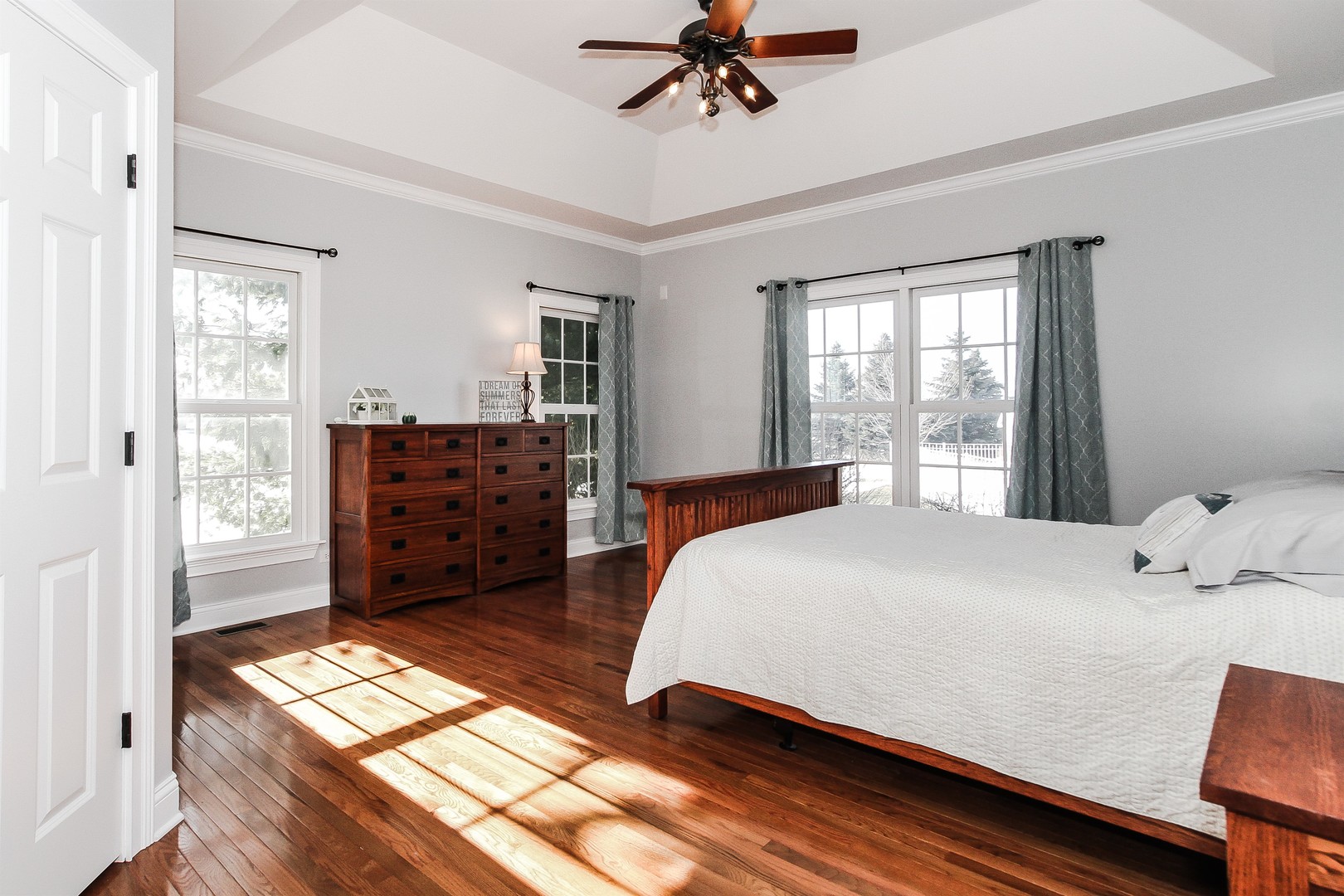 8762 Country Shire Lane Spring Grove, IL 60081 - Photo 21 of 39 a bedroom with a bed and a chandelier