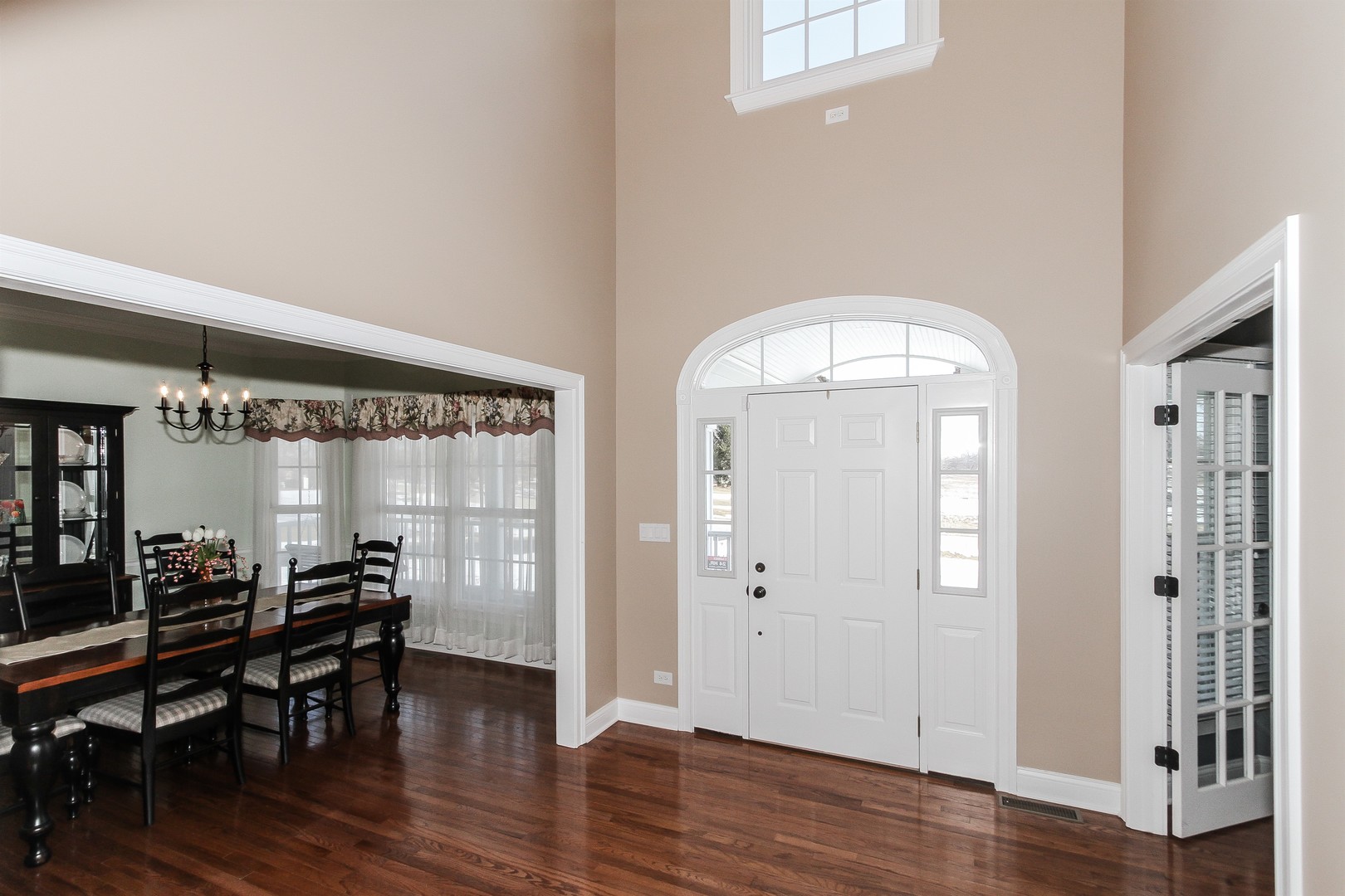 8762 Country Shire Lane Spring Grove, IL 60081 - Photo 4 of 39 a view of a room with wooden floor table and chairs