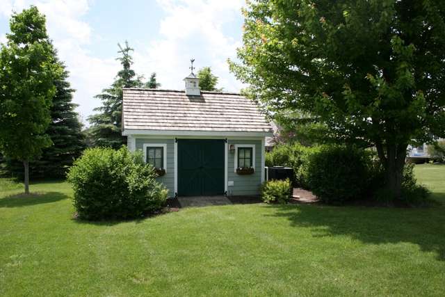 8762 Country Shire Lane Spring Grove, IL 60081 - Photo 37 of 39 a view of a house with garden and yard