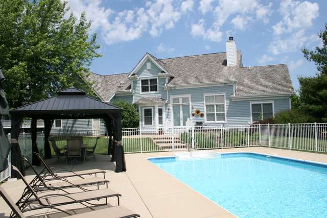 8762 Country Shire Lane Spring Grove, IL 60081 - Photo 38 of 39 a front view of a house with swimming pool