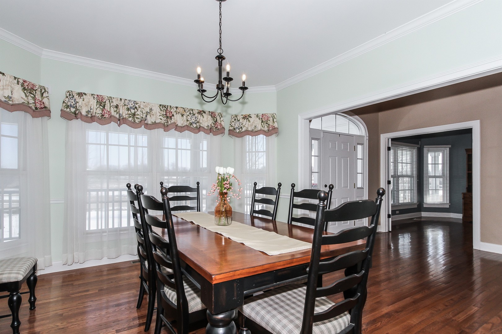 8762 Country Shire Lane Spring Grove, IL 60081 - Photo 6 of 39 a view of a dining room with furniture wooden floor and chandelier