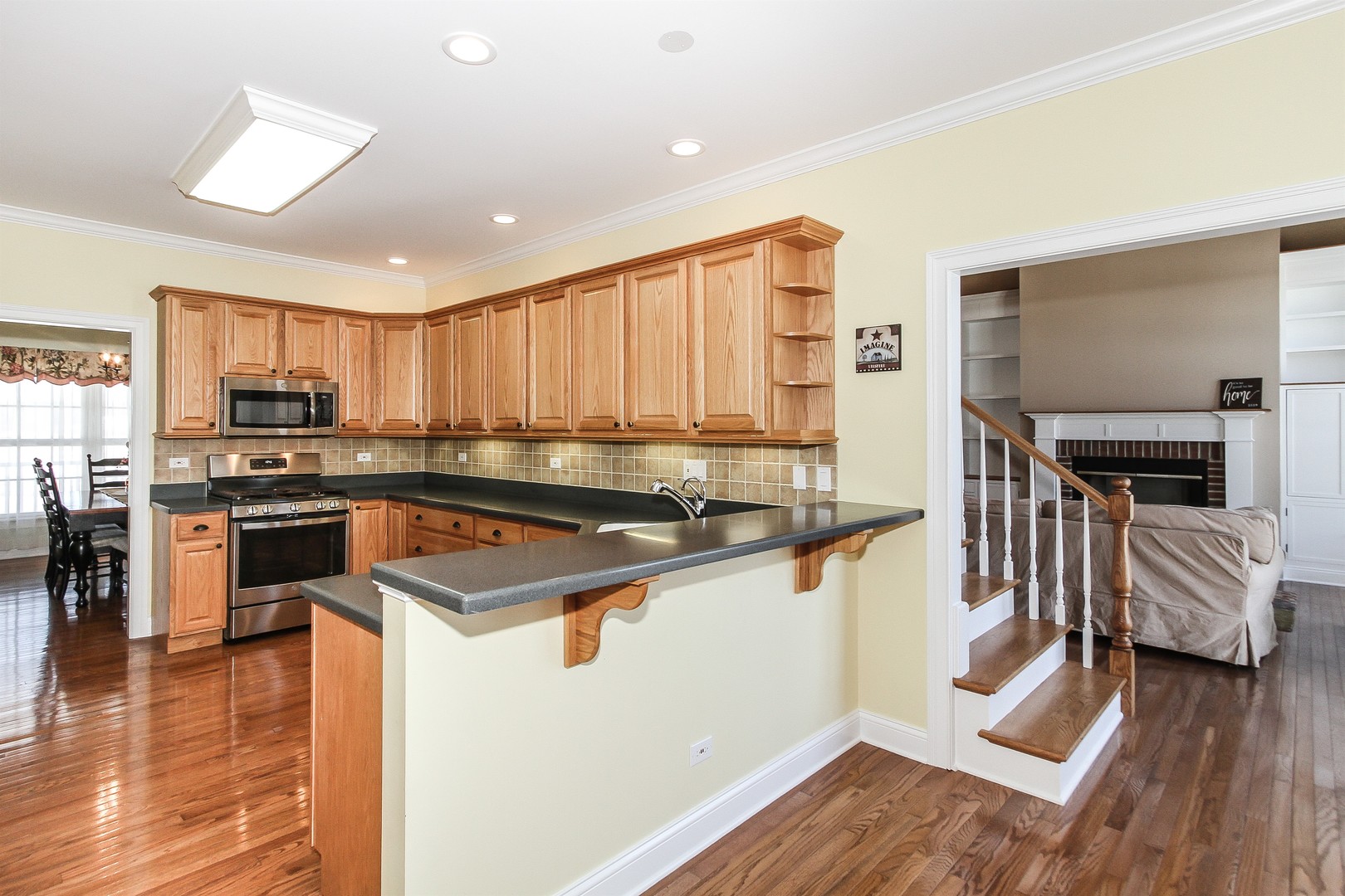 8762 Country Shire Lane Spring Grove, IL 60081 - Photo 10 of 39 a kitchen with stainless steel appliances granite countertop a stove a sink and a refrigerator