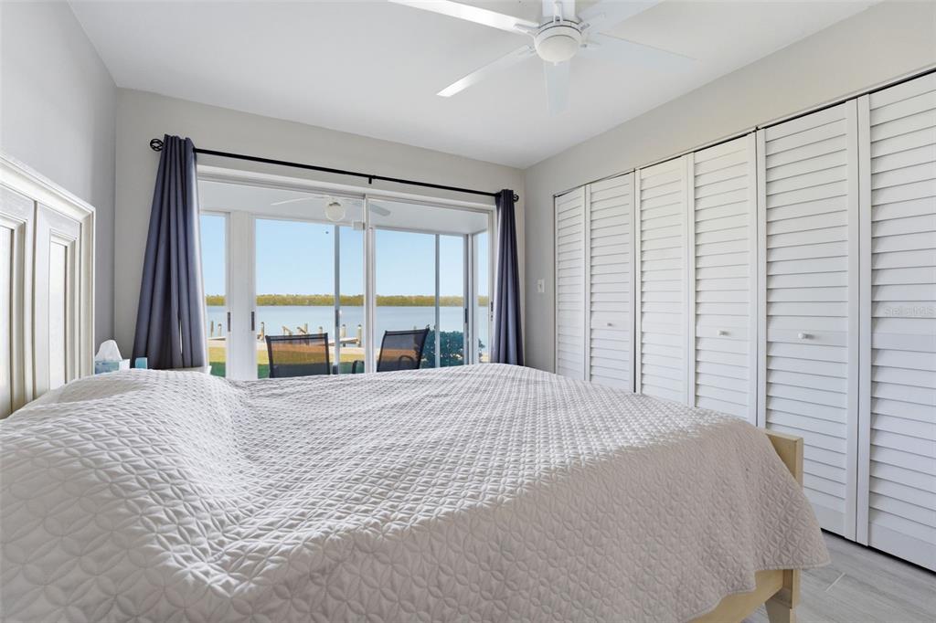 4440 Exeter Drive, Unit 106 Longboat Key, FL 34228 - Photo 12 of 26 a large bed sitting in a bedroom next to a window