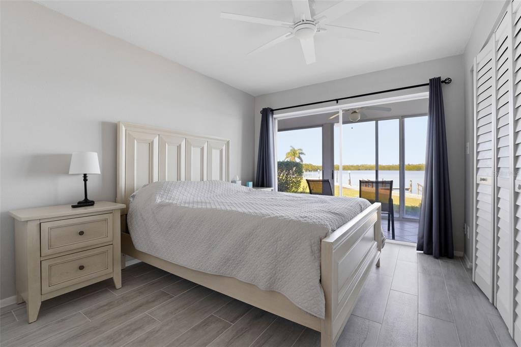 4440 Exeter Drive, Unit 106 Longboat Key, FL 34228 - Photo 13 of 26 a bed sitting in a bedroom next to a window