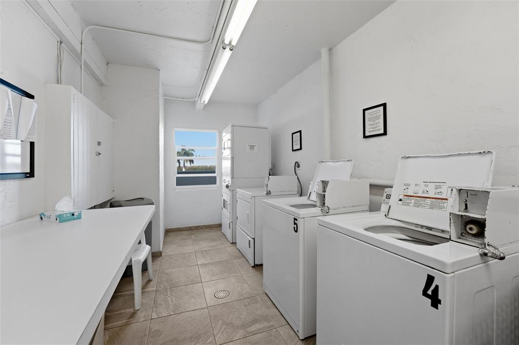 4440 Exeter Drive, Unit 106 Longboat Key, FL 34228 - Photo 18 of 26 a room with dryer and washer