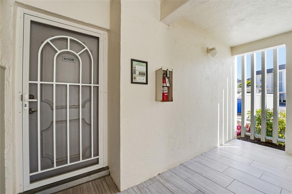 4440 Exeter Drive, Unit 106 Longboat Key, FL 34228 - Photo 2 of 26 a view of front door with wooden floor