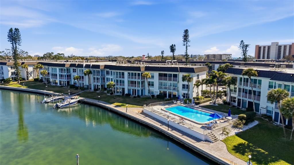 4440 Exeter Drive, Unit 106 Longboat Key, FL 34228 - Photo 23 of 26 a view of a lake with a chairs and lounge chair