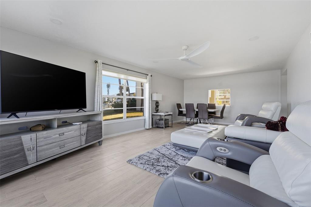 4440 Exeter Drive, Unit 106 Longboat Key, FL 34228 - Photo 8 of 26 a living room with furniture and a flat screen tv