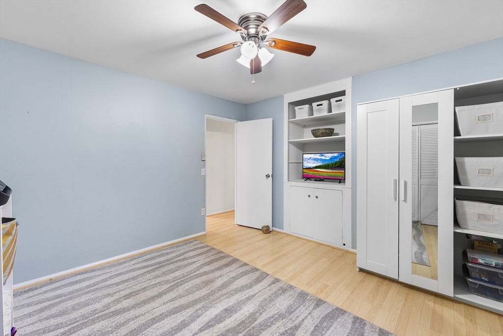 64 Cedar Hill Road Northborough, MA 01532 - Photo 18 of 27 a view of a livingroom with wooden floor and a ceiling fan