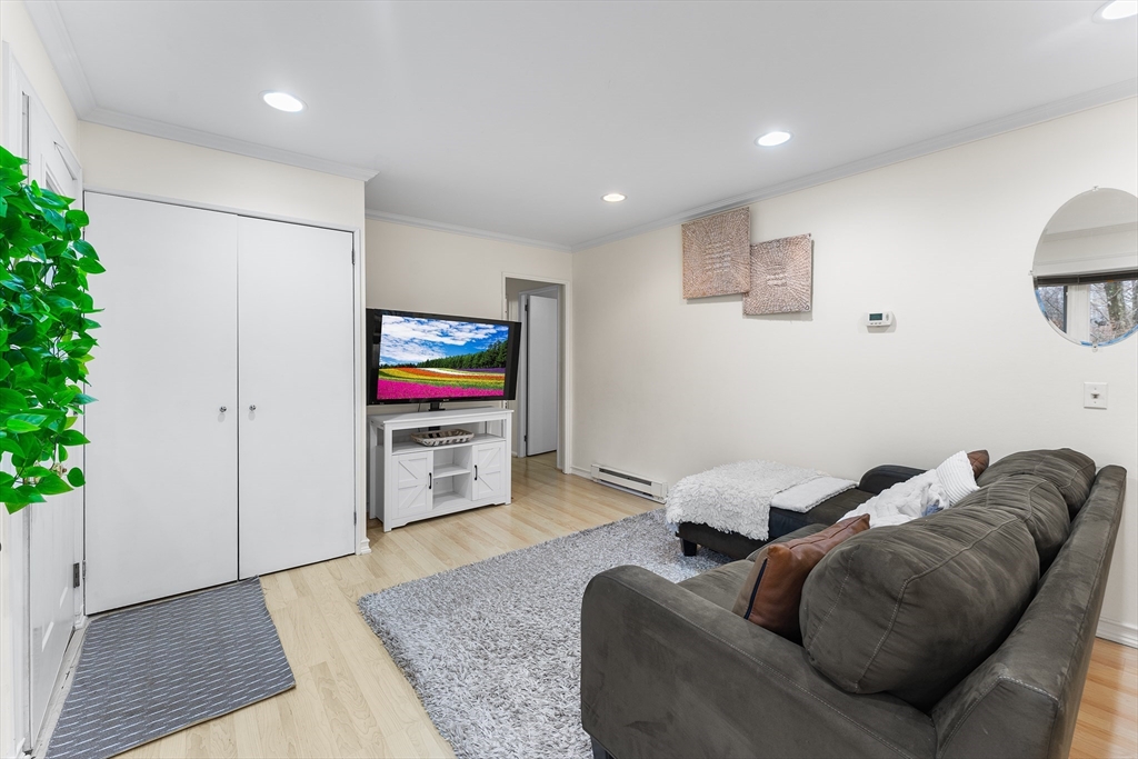 64 Cedar Hill Road Northborough, MA 01532 - Photo 3 of 27 a living room with furniture and a flat screen tv