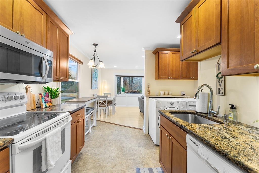 64 Cedar Hill Road Northborough, MA 01532 - Photo 8 of 27 a kitchen with a sink stove top oven and cabinets