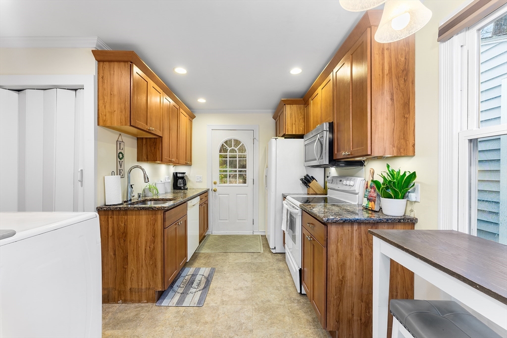 64 Cedar Hill Road Northborough, MA 01532 - Photo 10 of 27 a kitchen with stainless steel appliances granite countertop sink stove and refrigerator
