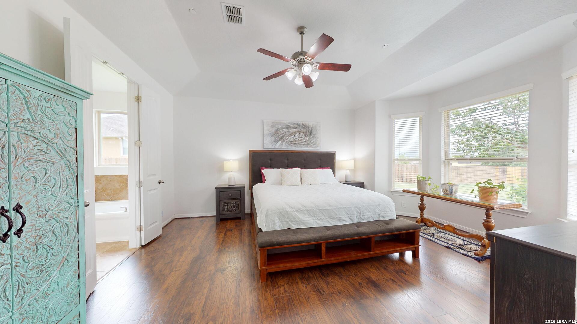 10111 Shallow Bank Converse, TX 78109 - Photo 41 of 65 a bedroom with a bed and wooden floor