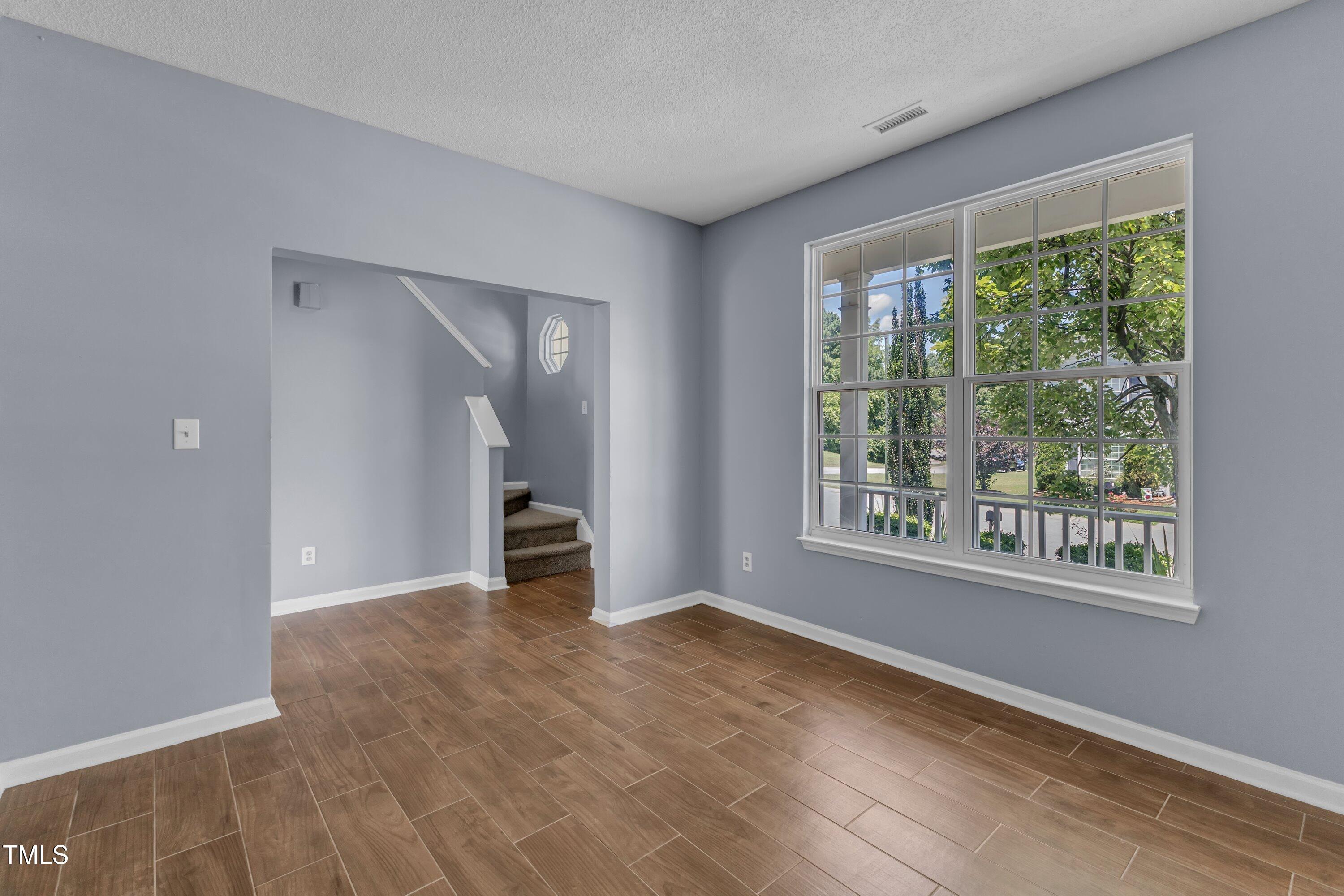 3604 Rivermist Drive Raleigh, NC 27610 - Photo 11 of 48 a view of empty room with wooden floor and fan