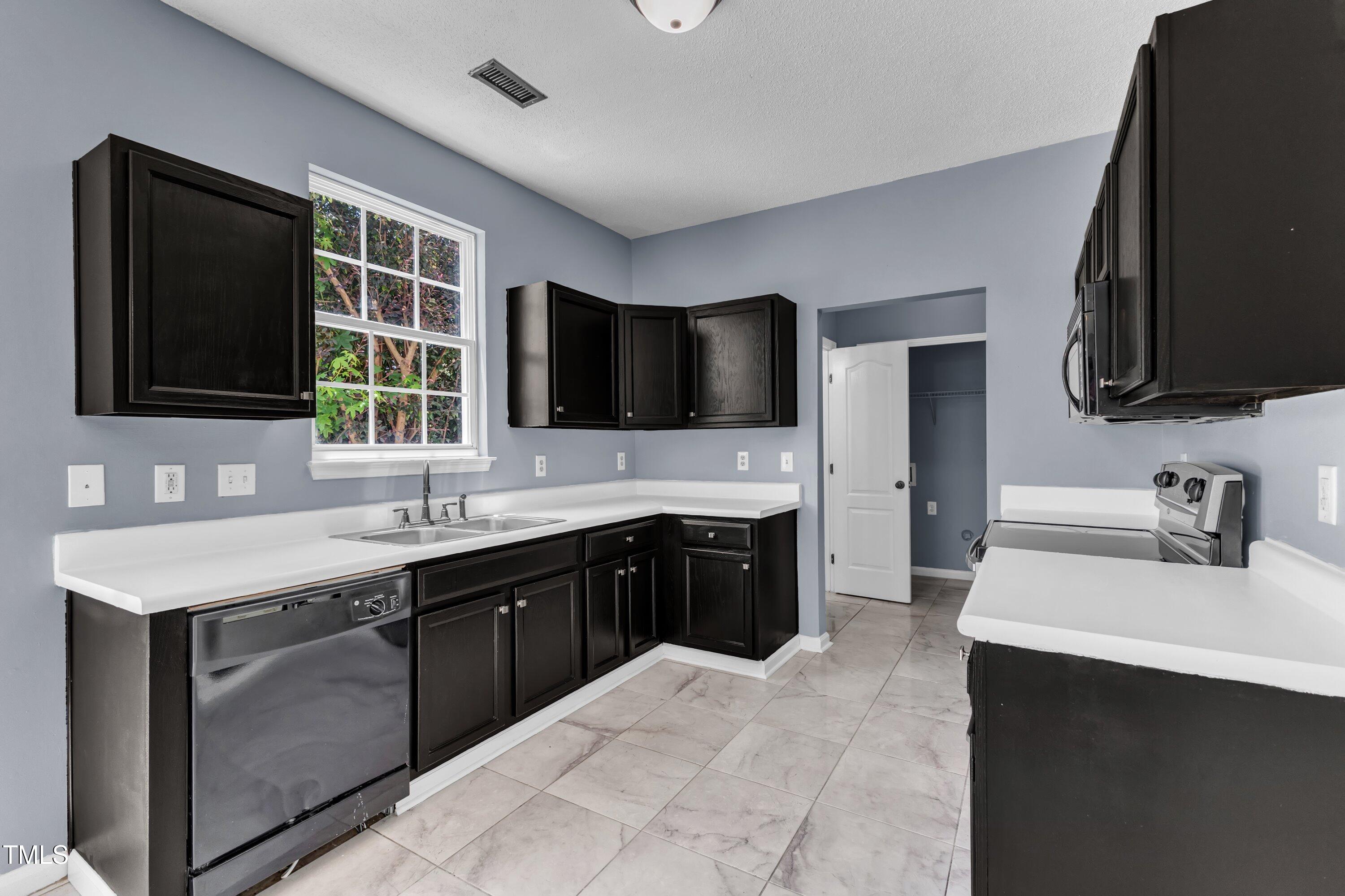 3604 Rivermist Drive Raleigh, NC 27610 - Photo 19 of 48 a kitchen with a sink stove and microwave
