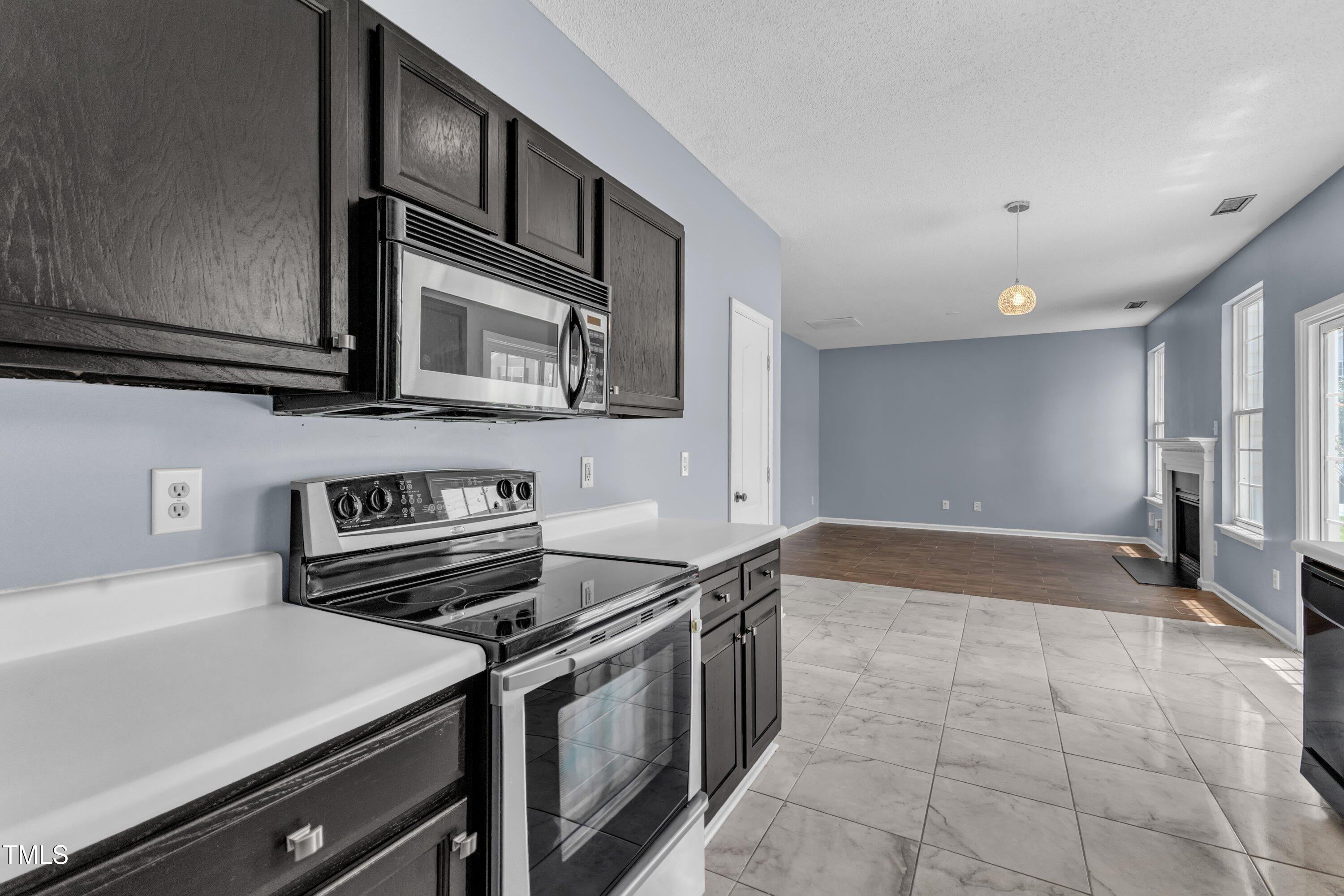 3604 Rivermist Drive Raleigh, NC 27610 - Photo 21 of 48 a kitchen with a stove and a microwave