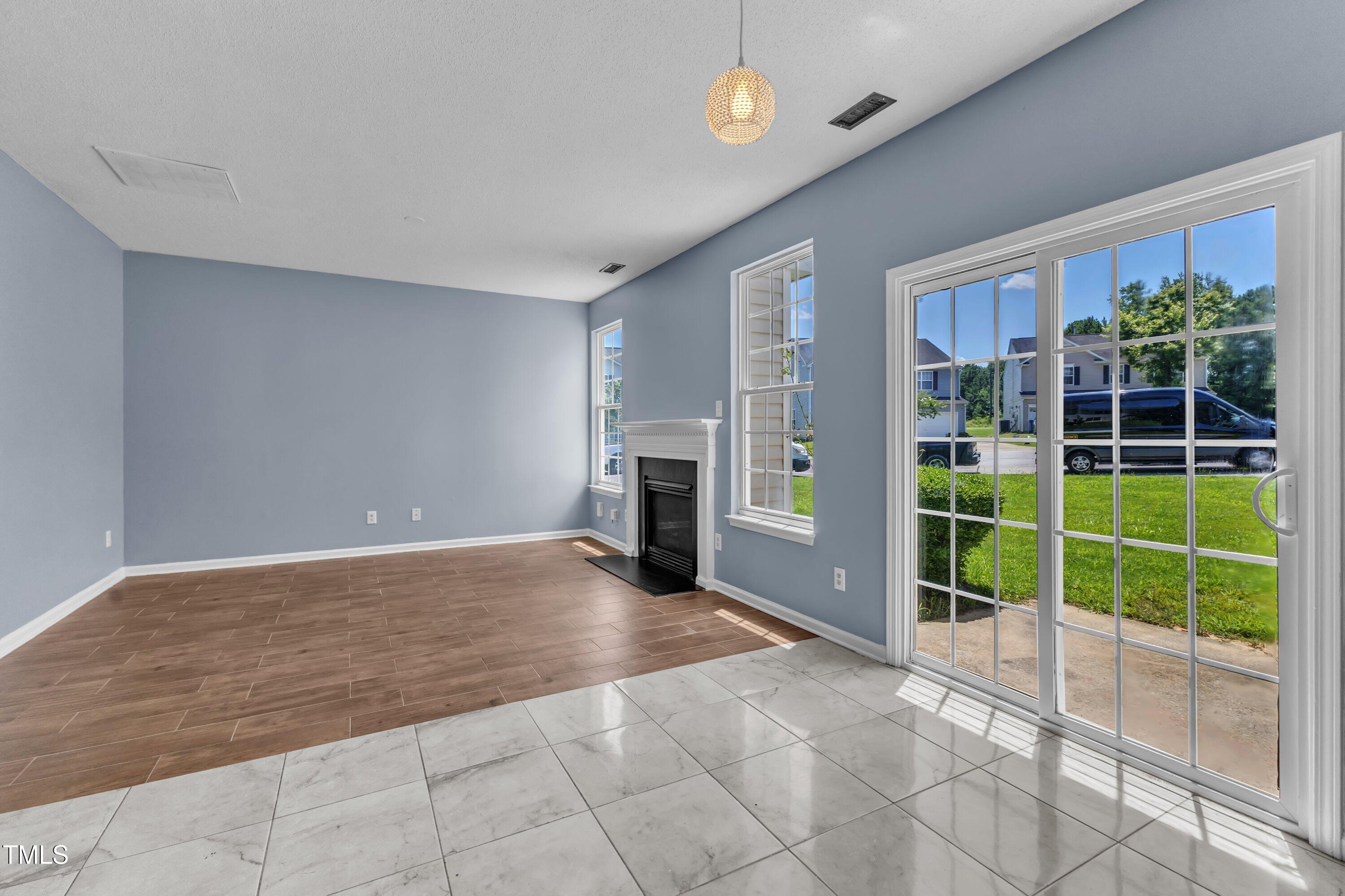 3604 Rivermist Drive Raleigh, NC 27610 - Photo 28 of 48 a view of a livingroom with a fireplace and a floor to ceiling window