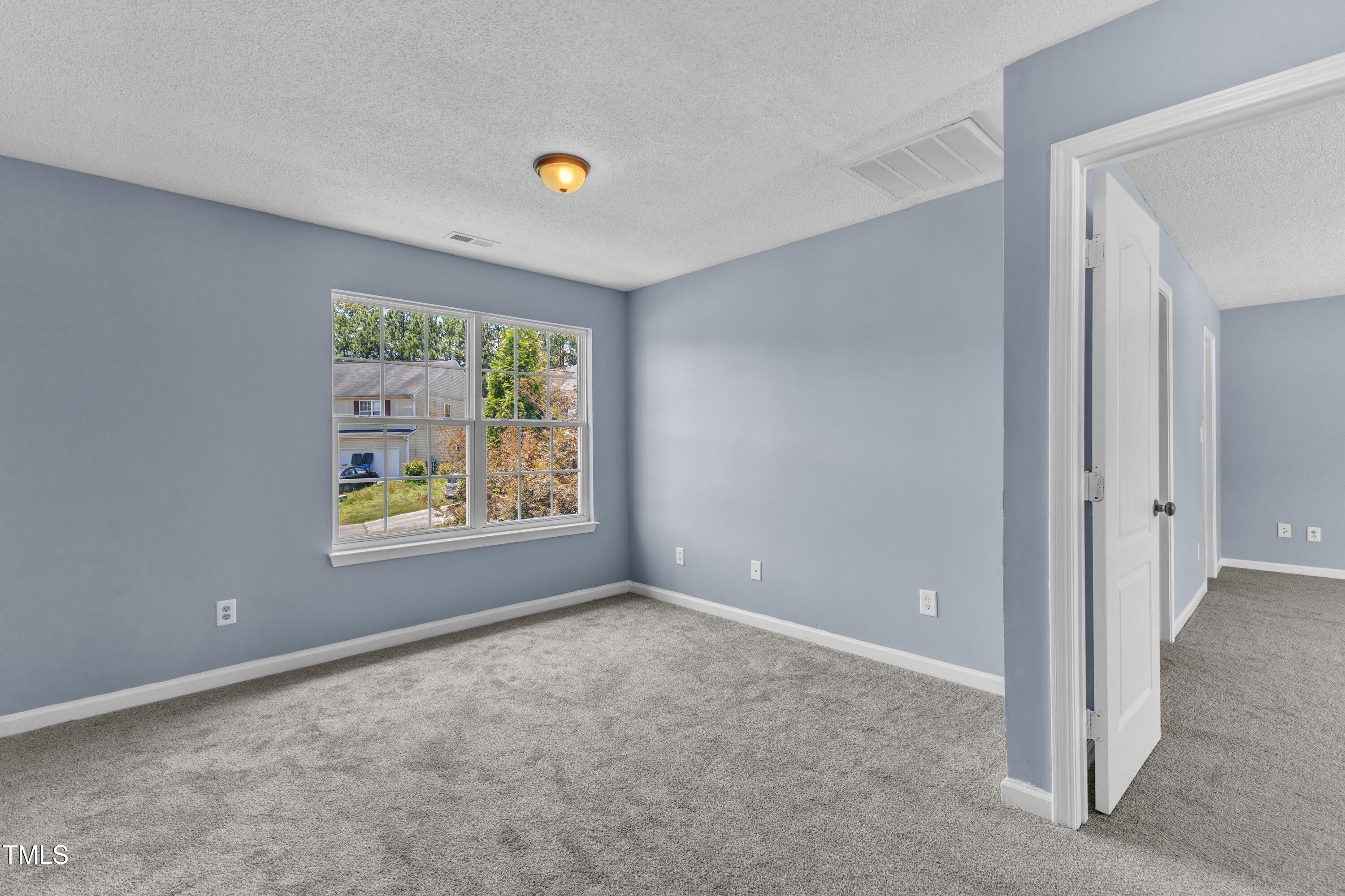 3604 Rivermist Drive Raleigh, NC 27610 - Photo 29 of 48 a view of an empty room with a window