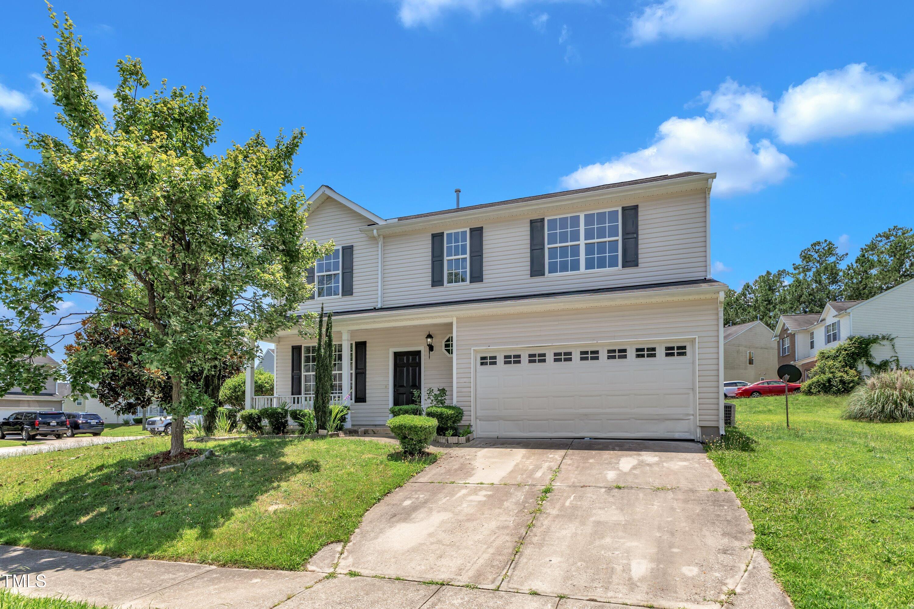 3604 Rivermist Drive Raleigh, NC 27610 - Photo 3 of 48 a front view of a house with a garden
