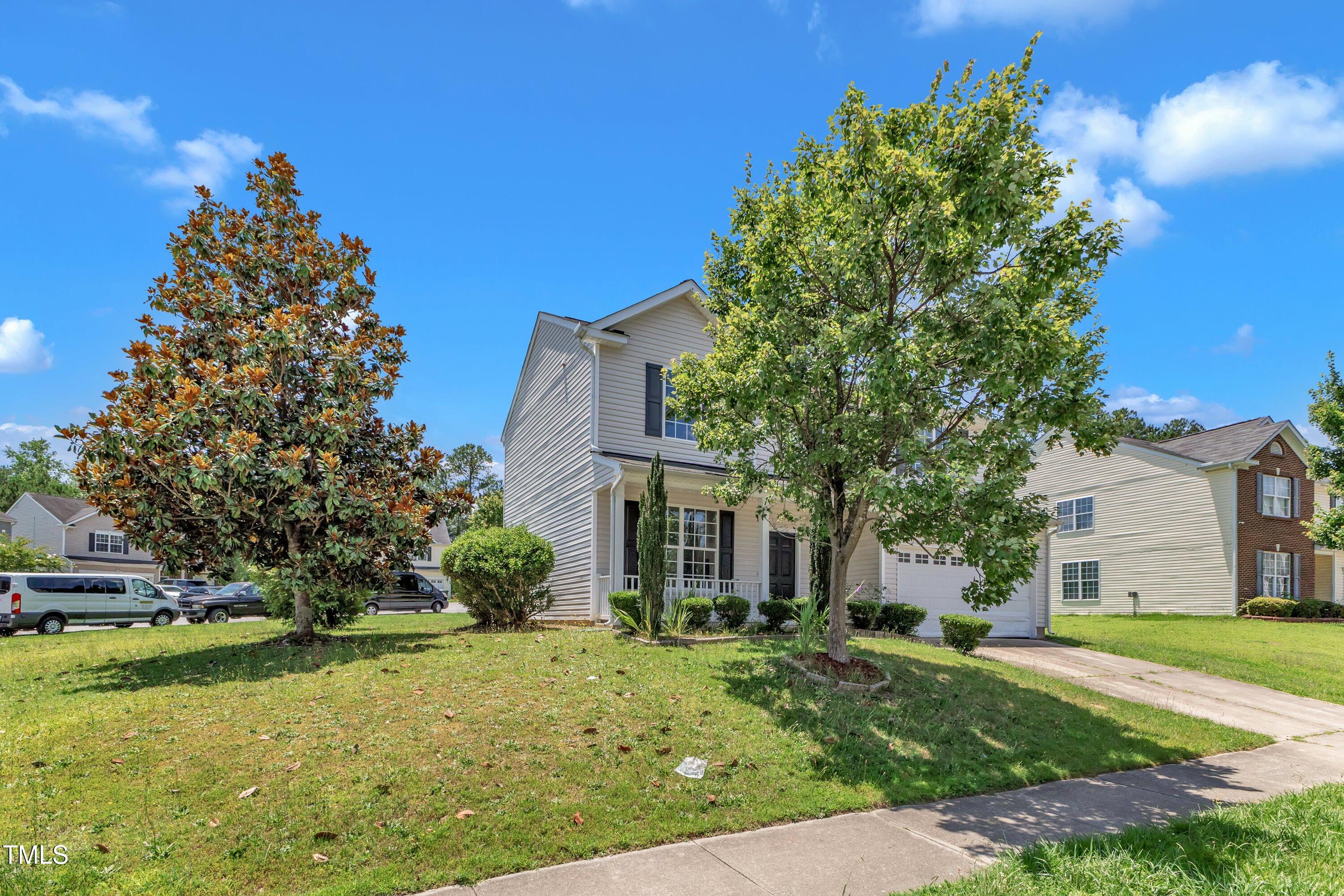 3604 Rivermist Drive Raleigh, NC 27610 - Photo 4 of 48 a front view of a house with garden