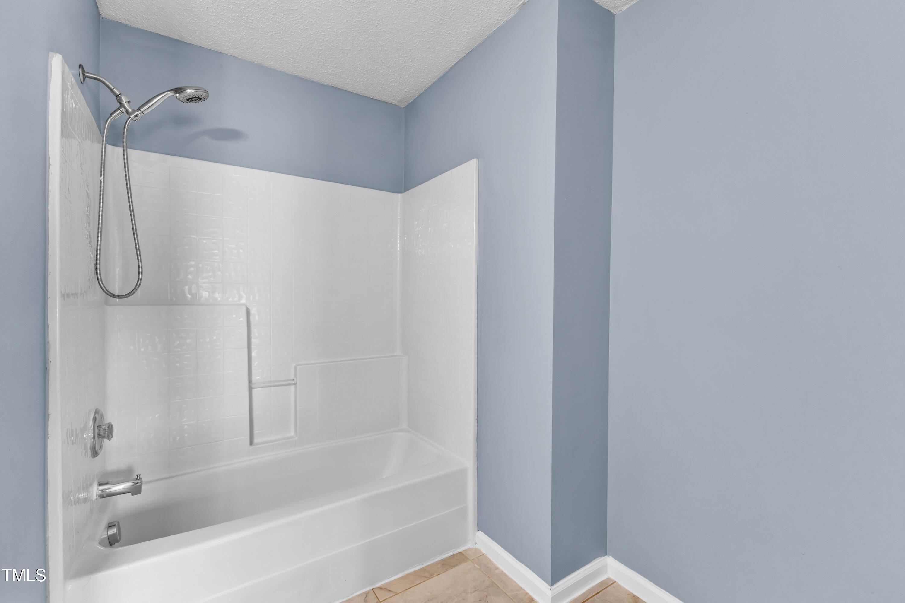 3604 Rivermist Drive Raleigh, NC 27610 - Photo 41 of 48 a bathroom with a shower and a bath tub