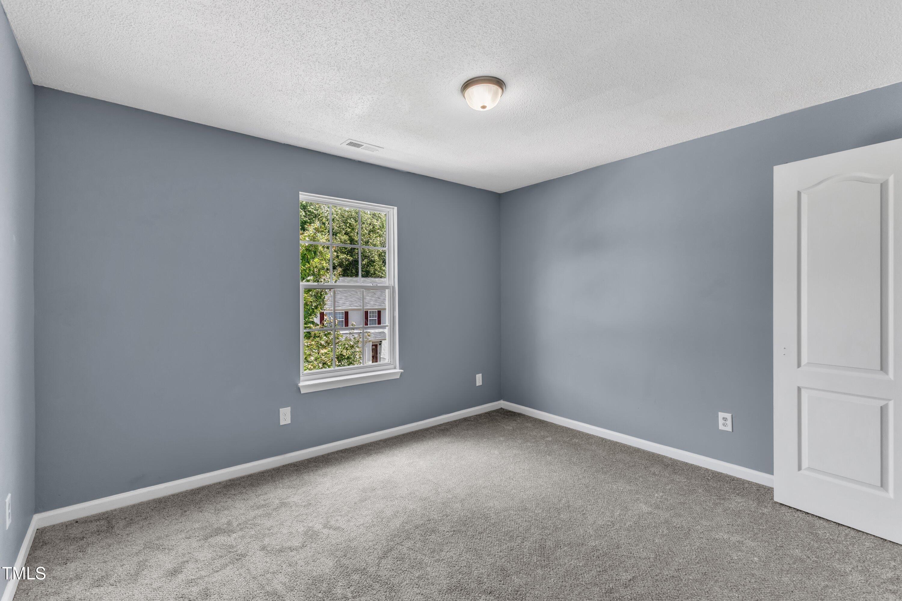 3604 Rivermist Drive Raleigh, NC 27610 - Photo 42 of 48 an empty room with windows