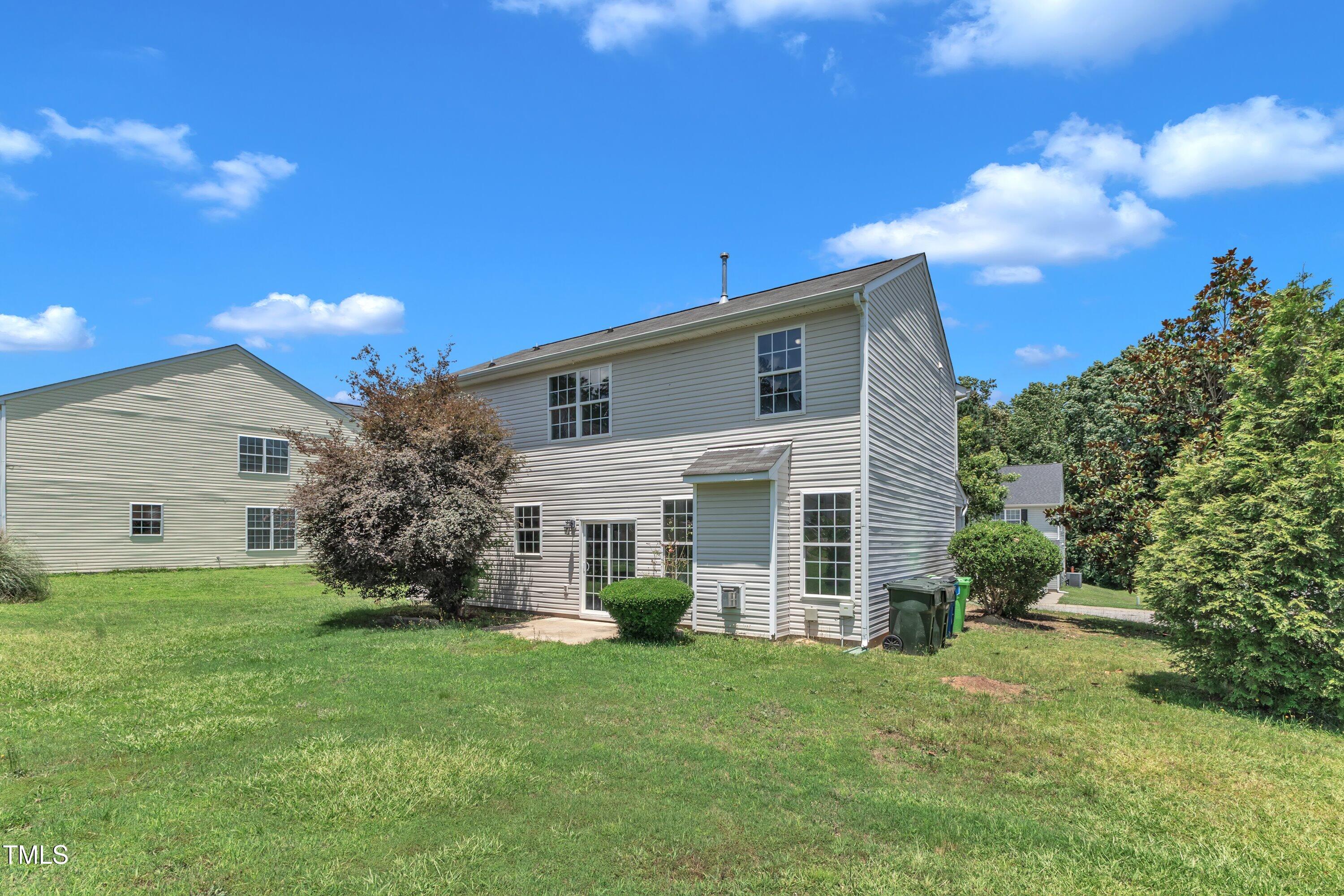 3604 Rivermist Drive Raleigh, NC 27610 - Photo 45 of 48 a front view of a house with a yard and garage