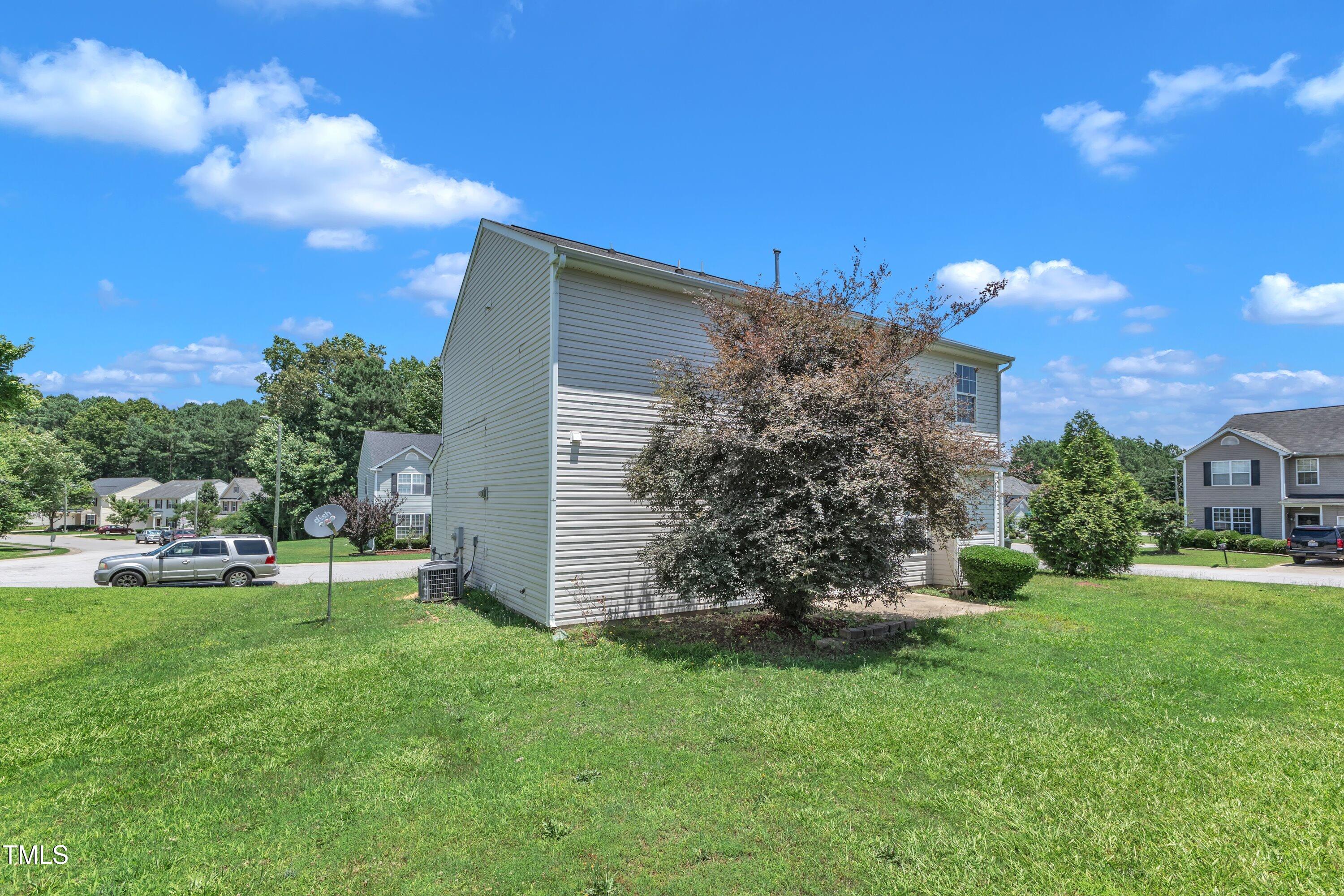 3604 Rivermist Drive Raleigh, NC 27610 - Photo 46 of 48 a view of a backyard with plants and large trees