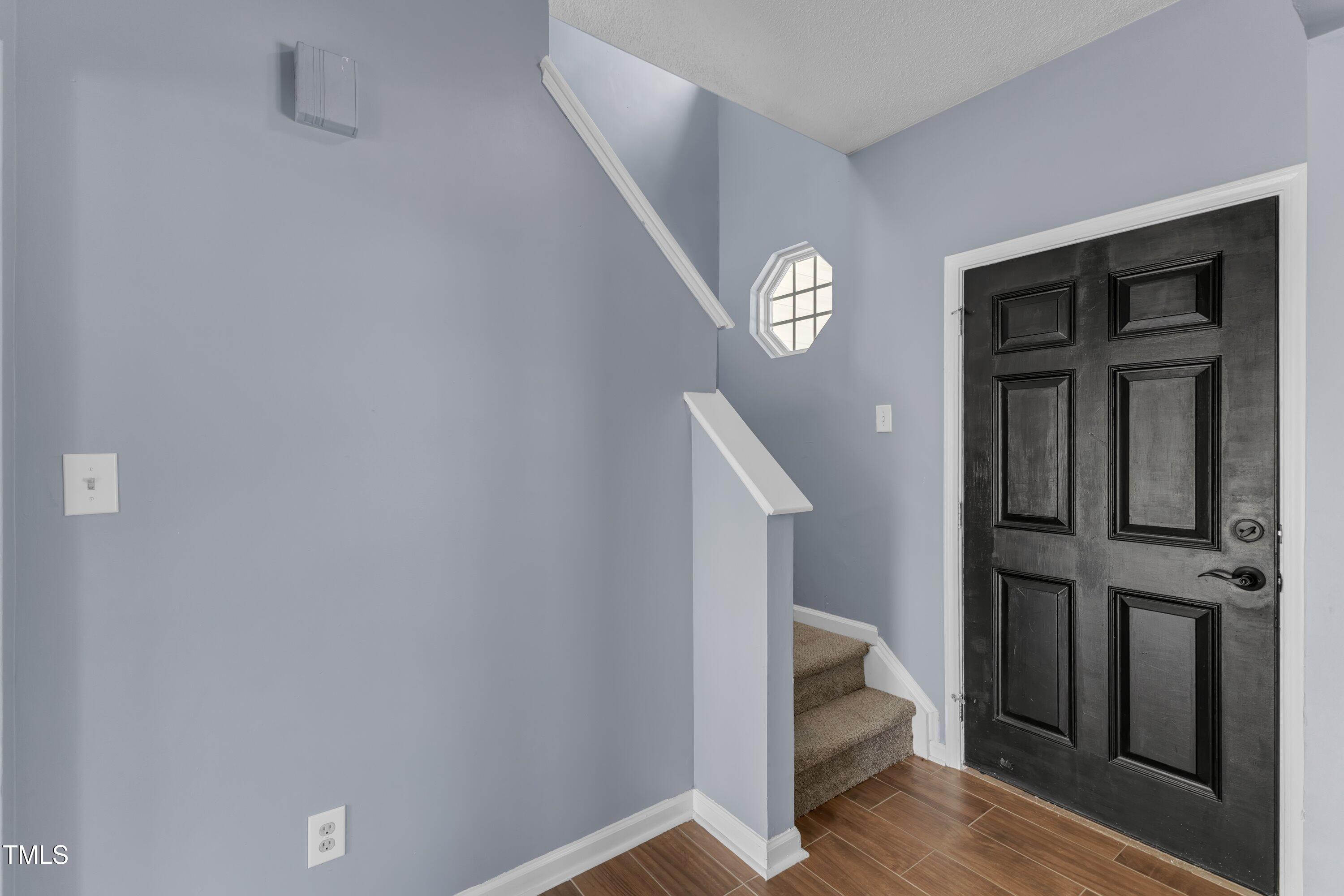 3604 Rivermist Drive Raleigh, NC 27610 - Photo 9 of 48 a view of entryway with stairs and wooden floor