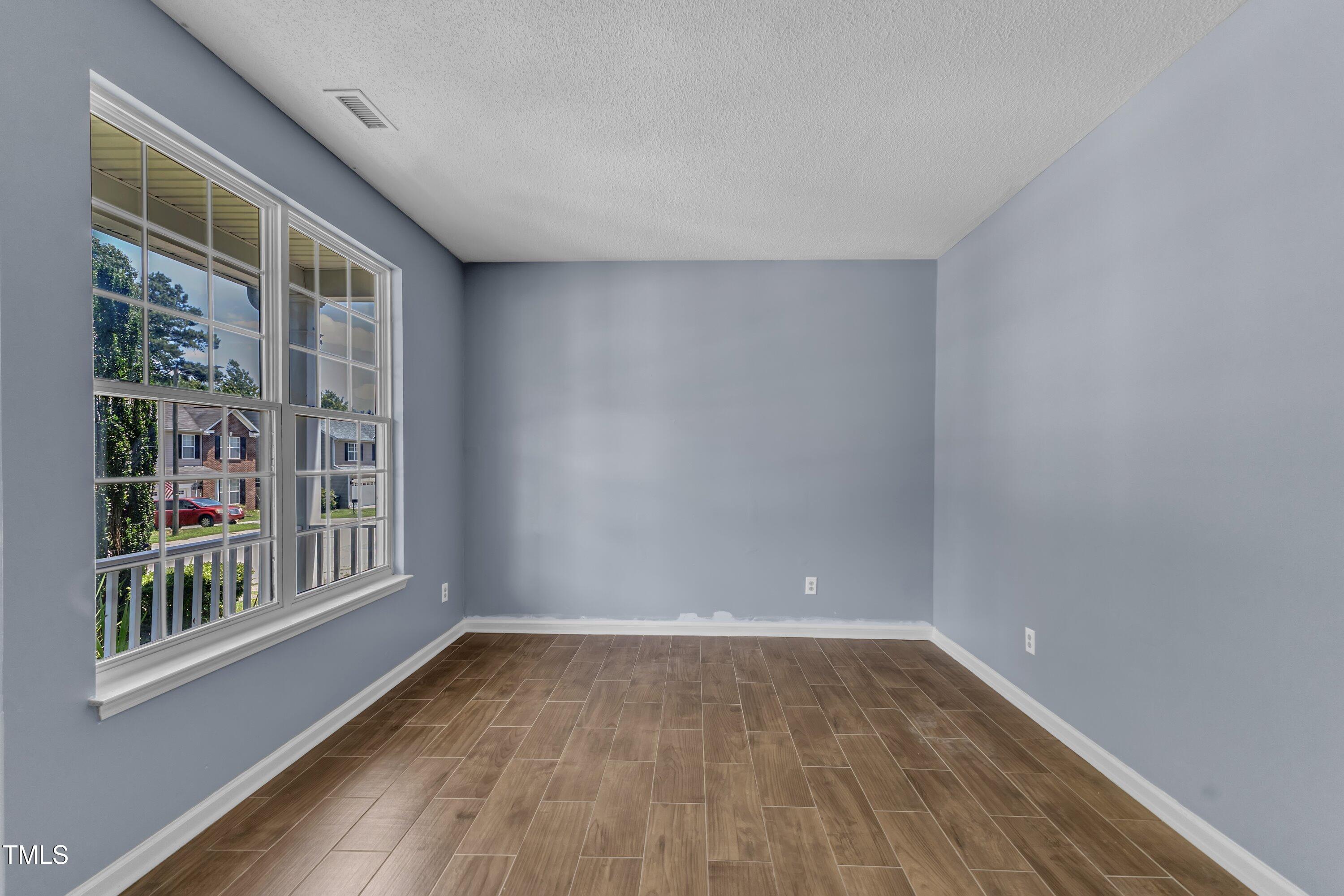 3604 Rivermist Drive Raleigh, NC 27610 - Photo 10 of 48 a big room with wooden floor and windows