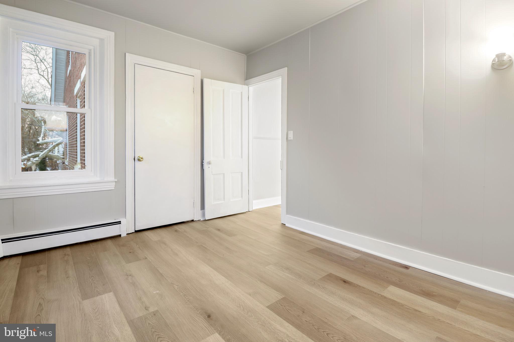 77 7th Street Salem, NJ 08079 - Photo 14 of 15 an empty room with wooden floor and windows