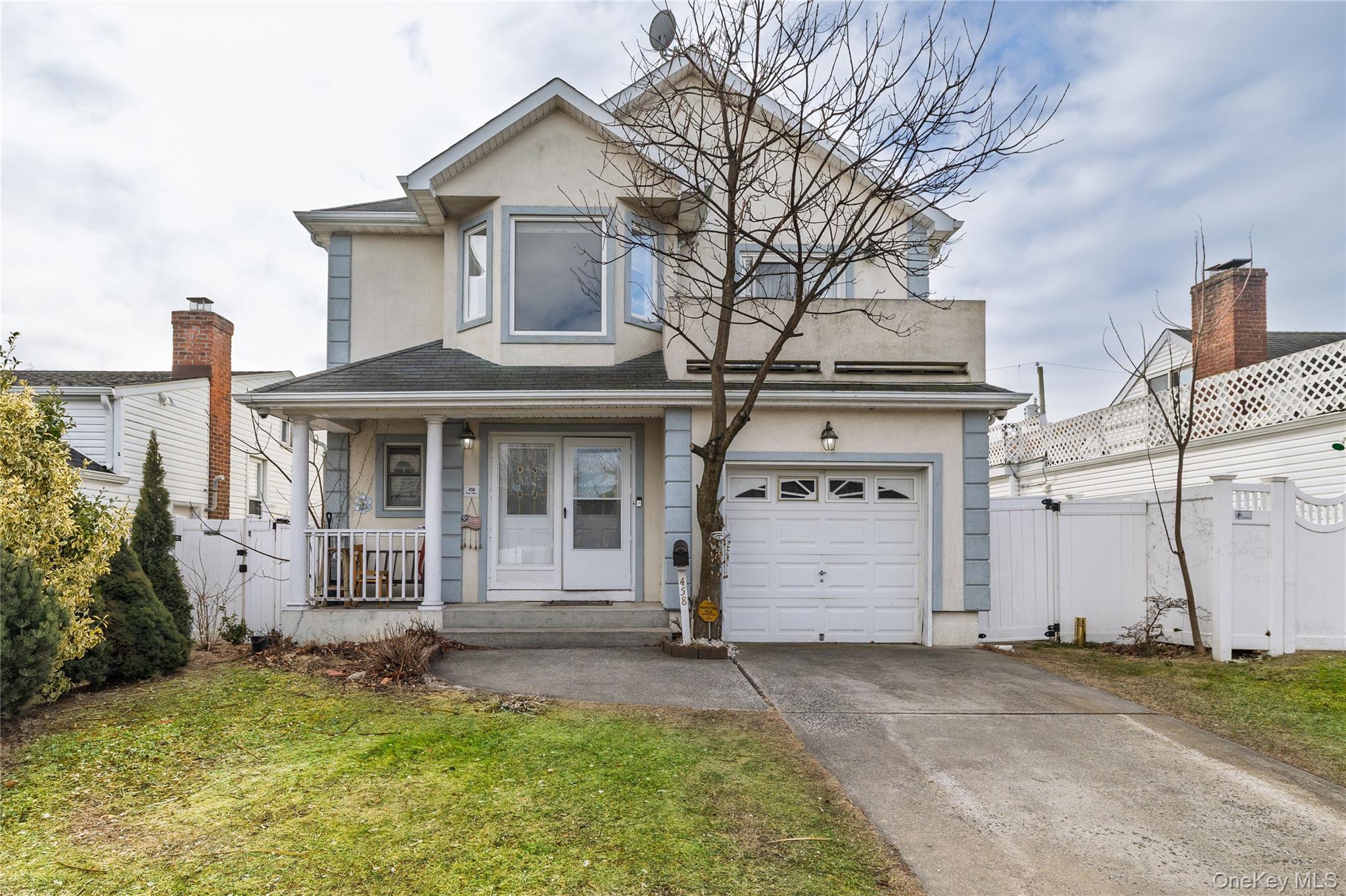 458 East Pine Street Long Beach, NY 11561 - Photo 1 of 26 a view of a white house with a yard and garage