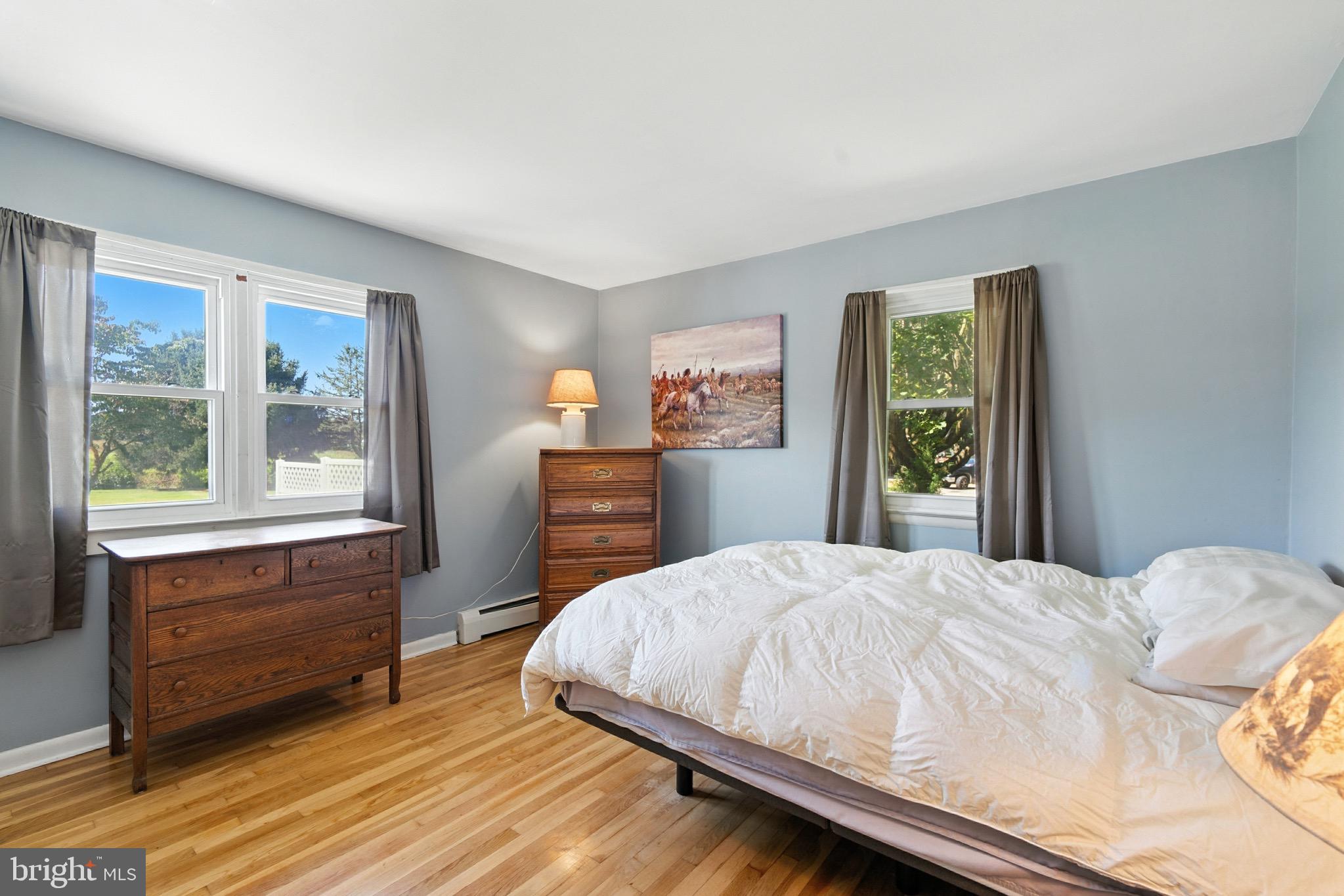 24415 Chestertown Road Chestertown, MD 21620 - Photo 11 of 29 a bedroom with a bed and wooden floor