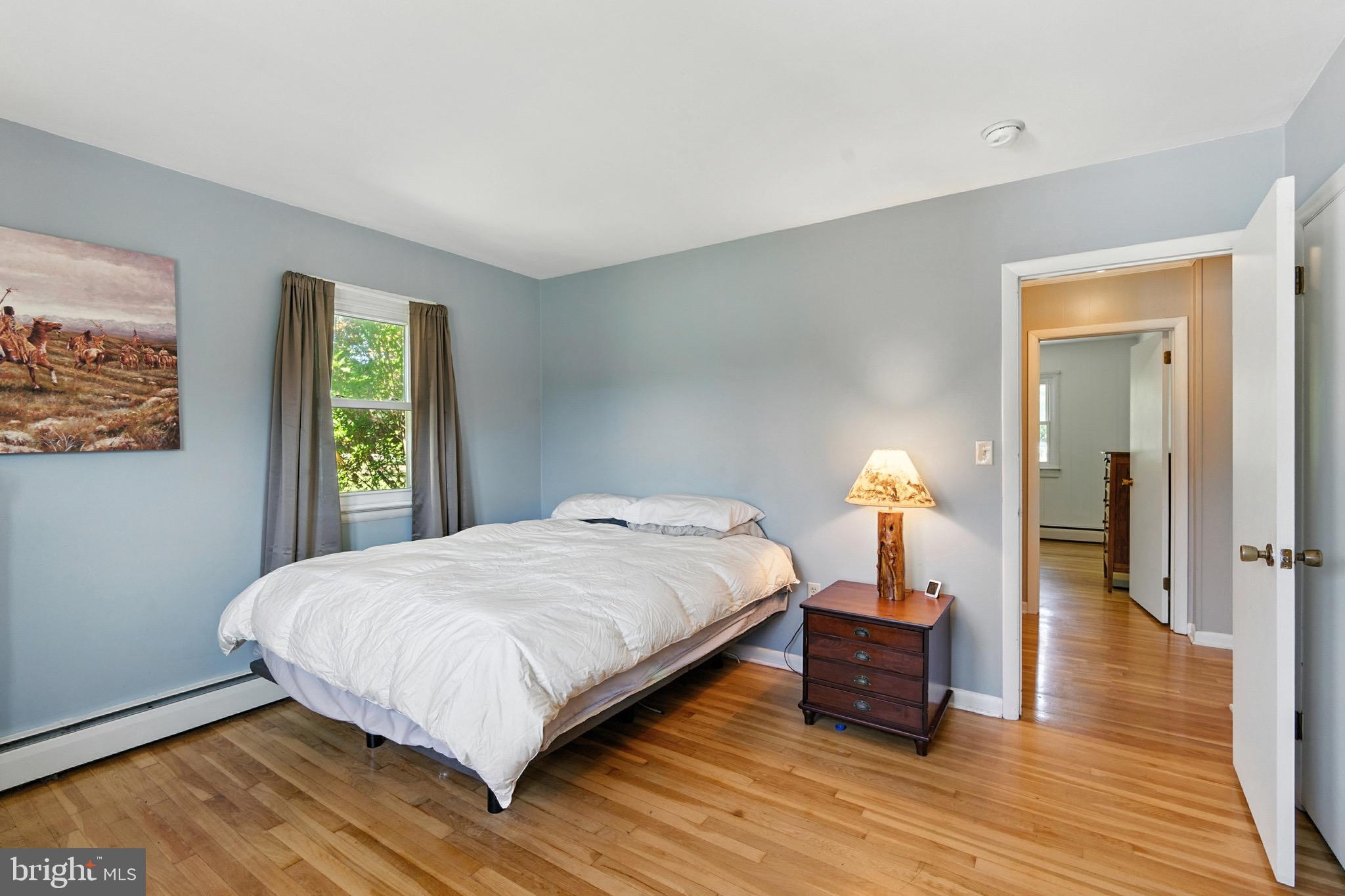 24415 Chestertown Road Chestertown, MD 21620 - Photo 12 of 29 a bedroom with a bed and wooden floor